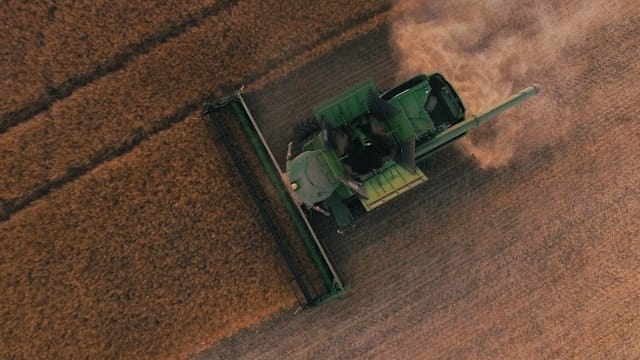 Drone image of harvesting machine in plantation